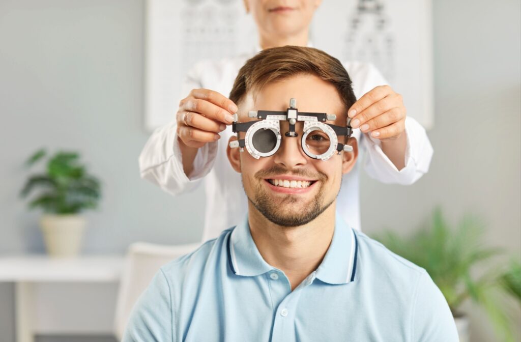 An optometrist tests their patient's eyesight during an eye exam.