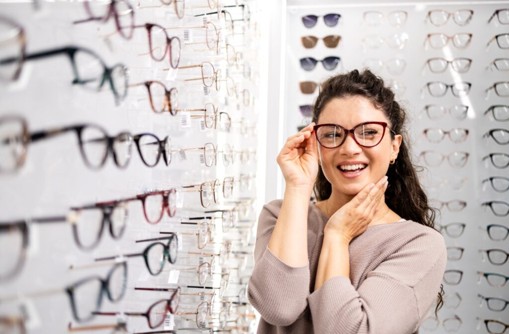 A person trying on a pair of brown glasses at the optometrists in Liberty Village