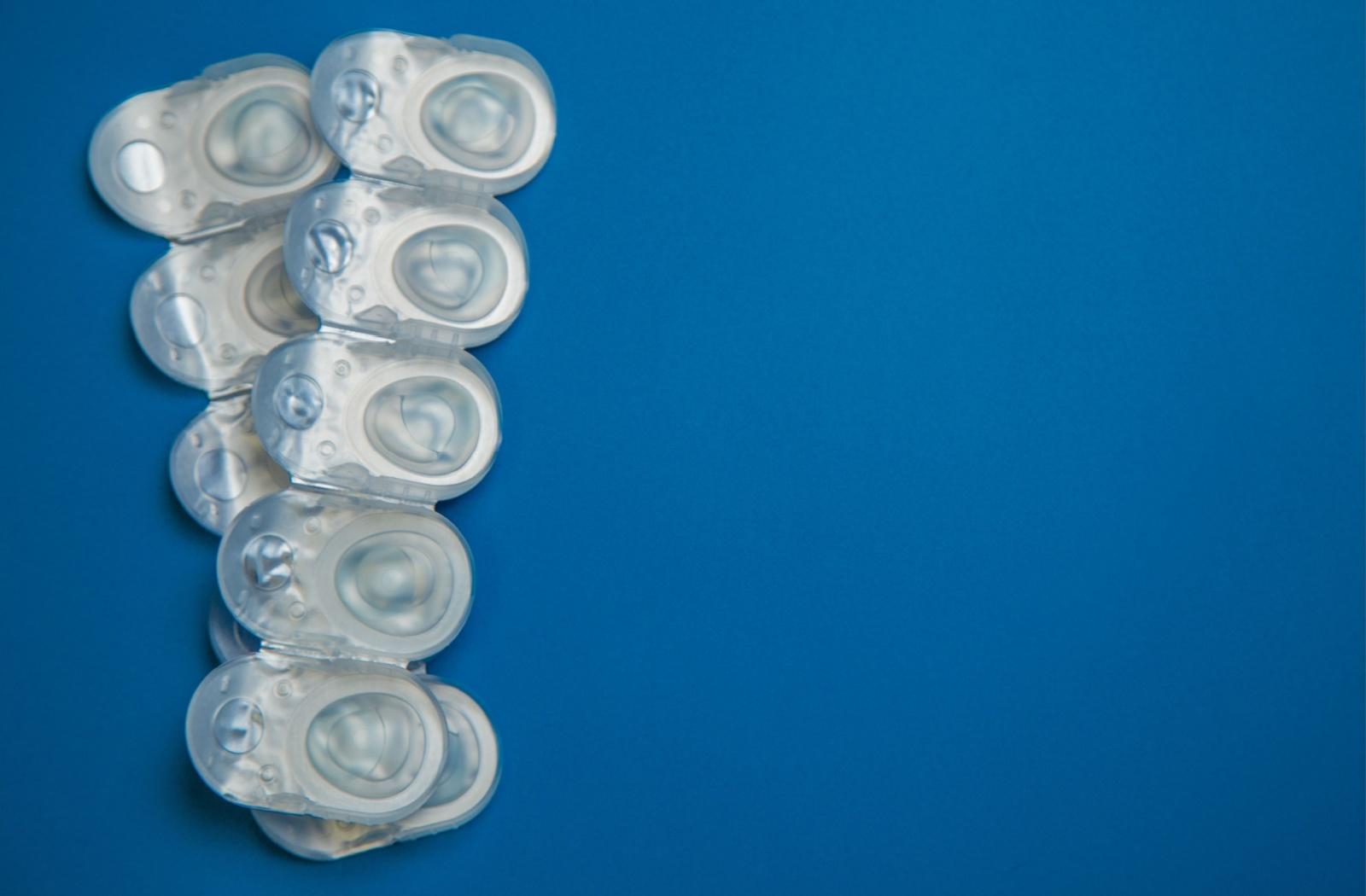 A row of 5 blister packs containing contact lenses